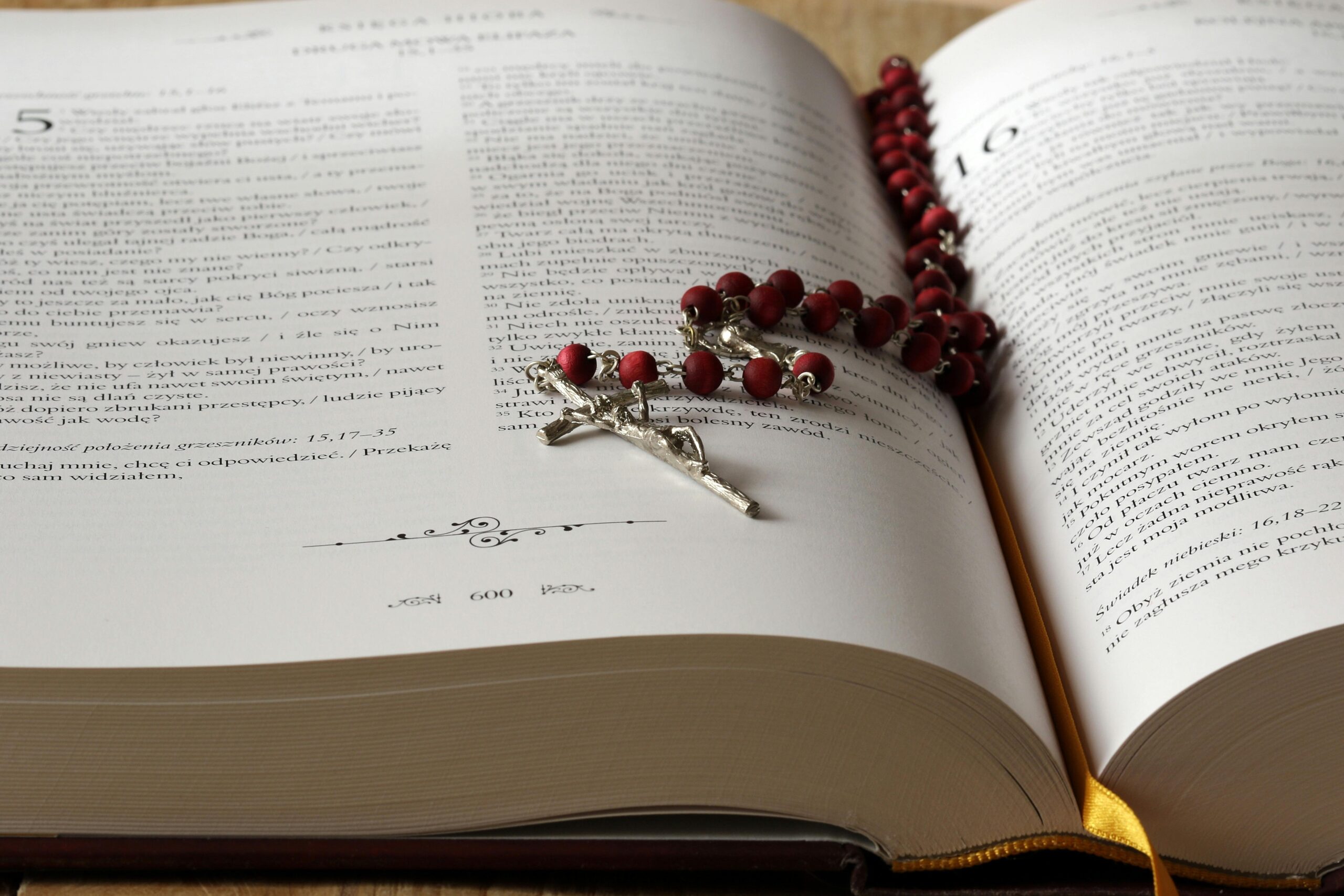 A bible is open on the counter, with a rosary draped in the crevice of the open pages